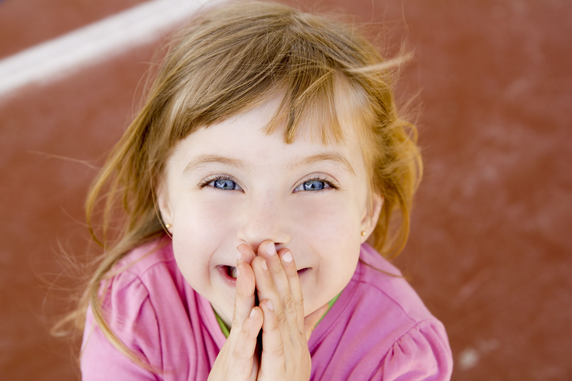 Blond Happy Smiling Little Girl Excited Laugh Hands In Mouth