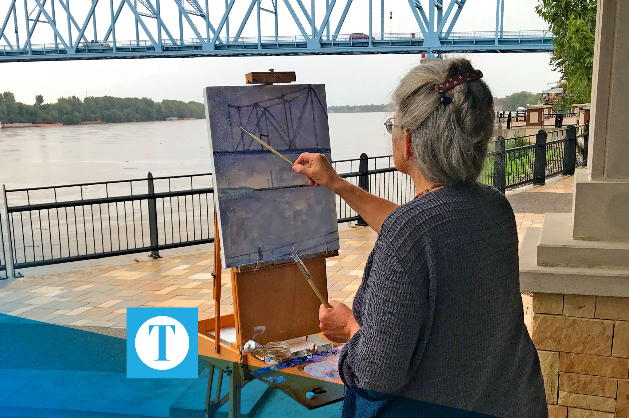 woman painting bridge